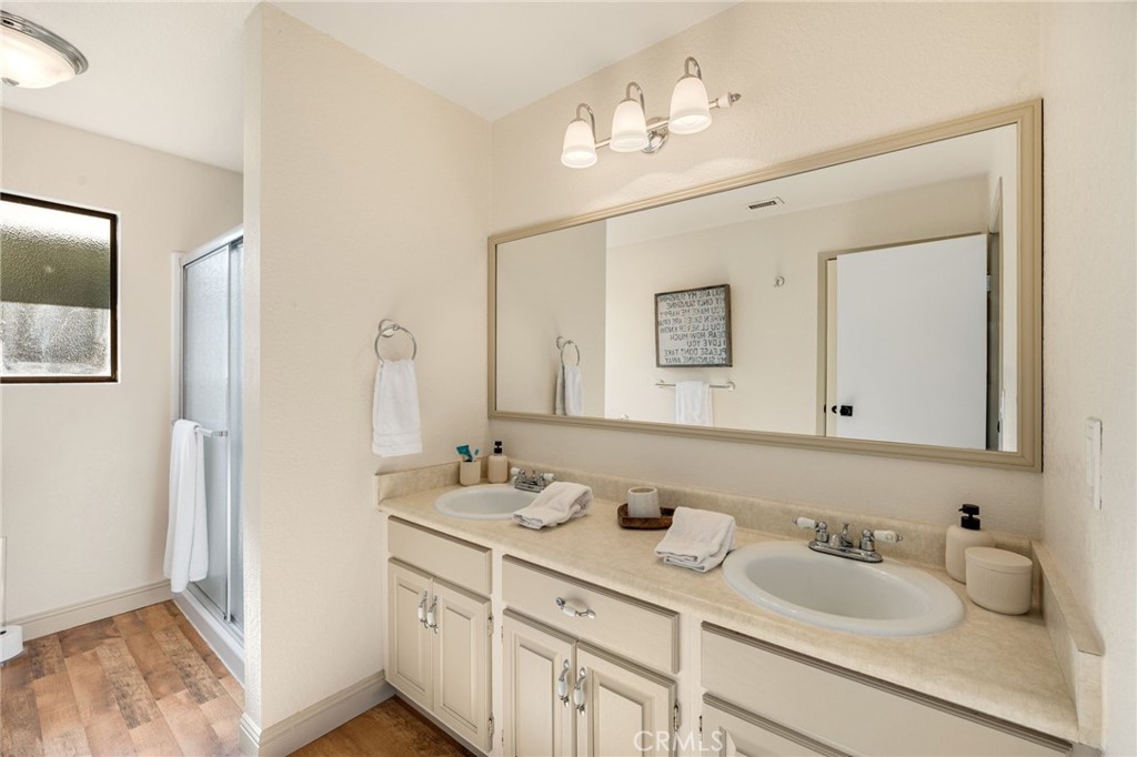 48980 De Luz Road Temecula, CA 92590 - Photo 28 of 50 a bathroom with a granite countertop sink double and mirror