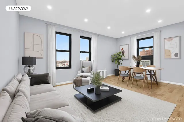 a living room with furniture potted plant and a window