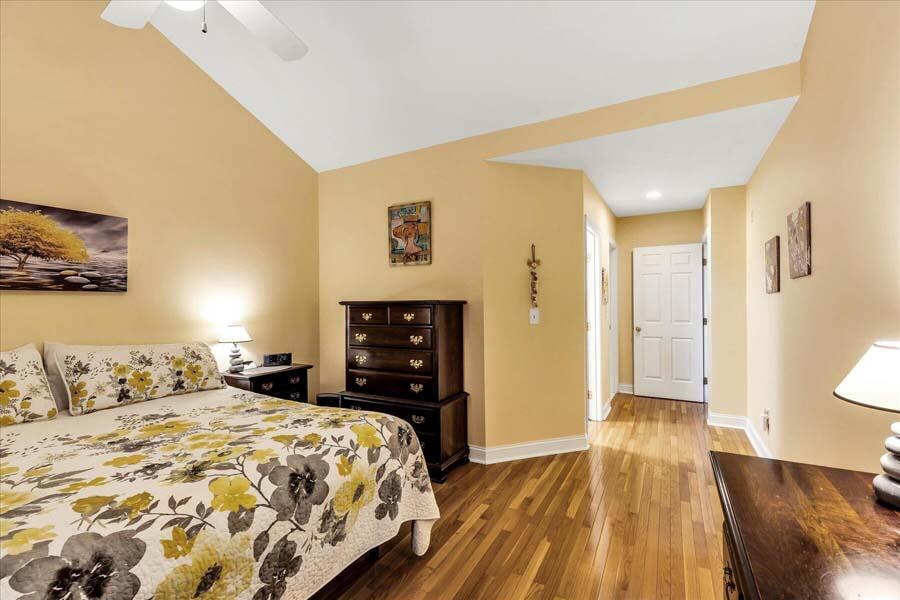24 Stratford Ridge Mashpee, MA 02649 - Photo 34 of 50 a bedroom with a bed and wooden floor