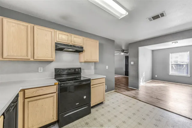 a kitchen with stainless steel appliances granite countertop a stove and a refrigerator