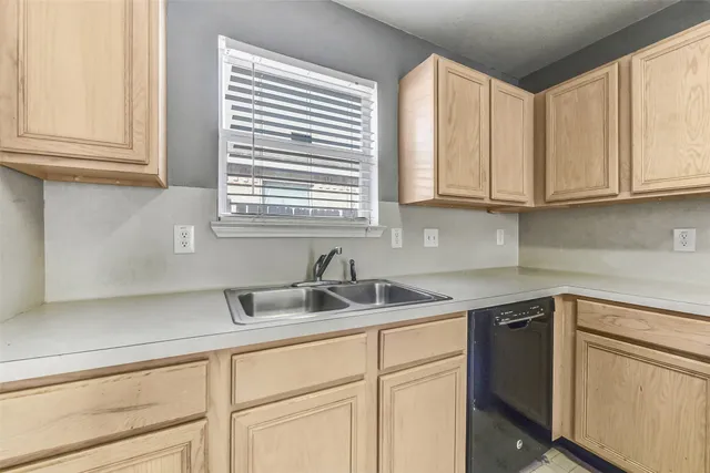 a kitchen with stainless steel appliances granite countertop a sink and a white cabinets