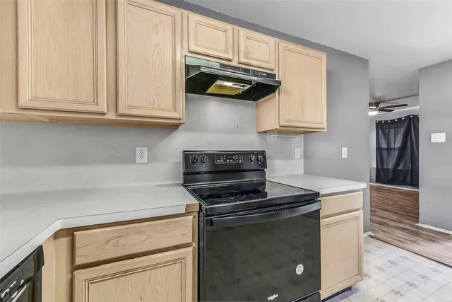 a kitchen with stainless steel appliances granite countertop a stove and a refrigerator with white cabinets