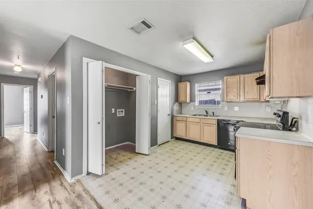 a kitchen with a stove a refrigerator and a sink