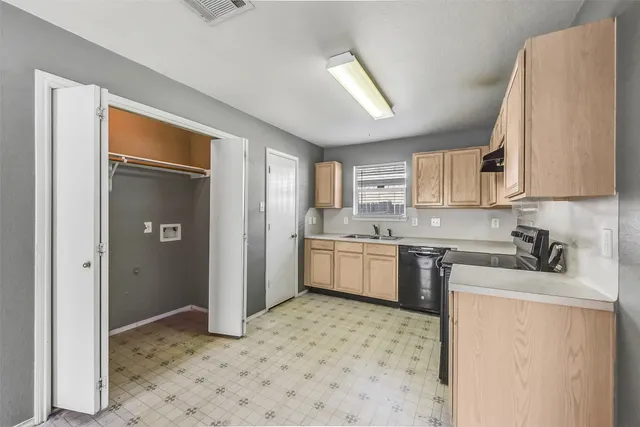 a kitchen with a refrigerator sink stove and cabinets
