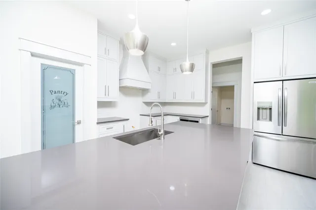 a kitchen with stainless steel appliances a refrigerator and a sink