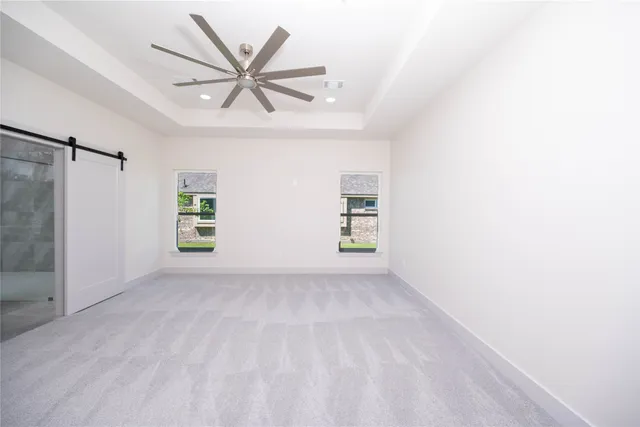 a view of a livingroom with a ceiling fan and window