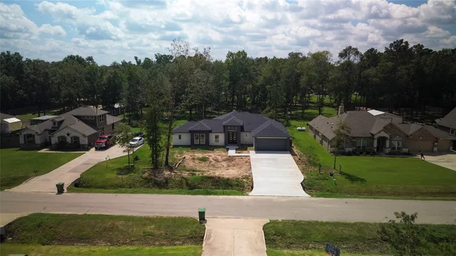 an aerial view of a house with a yard
