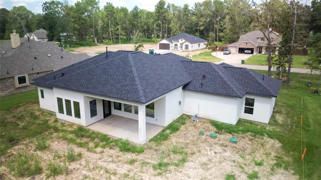 a aerial view of a house with swimming pool and sitting area