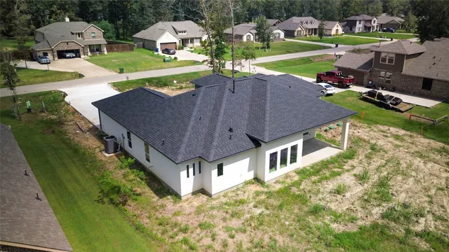 an aerial view of a house with a big yard