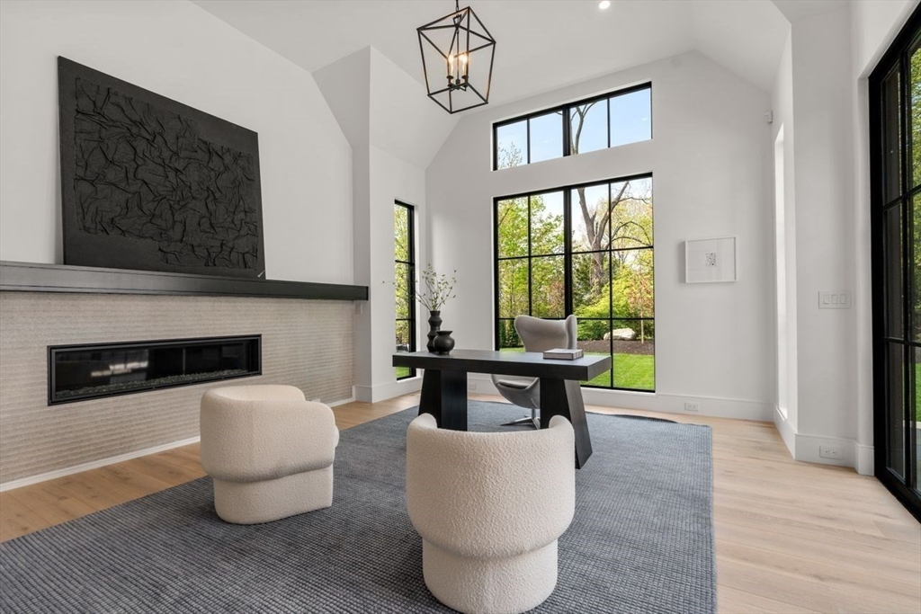 279 Fuller Street Newton, MA 02465 - Photo 11 of 42 a living room with furniture a fireplace and a floor to ceiling window