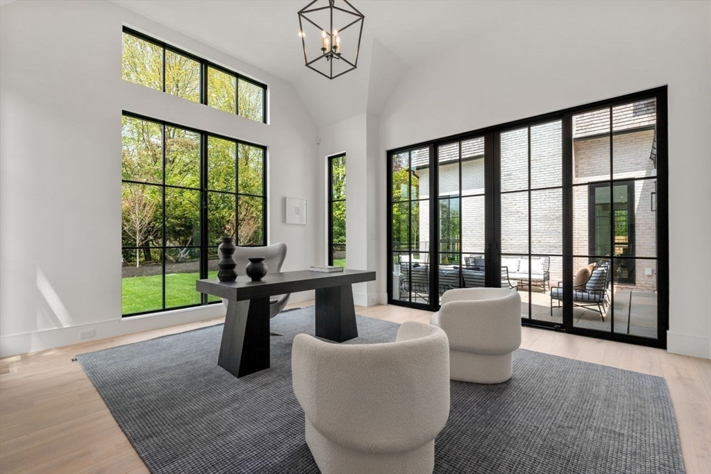 279 Fuller Street Newton, MA 02465 - Photo 12 of 42 a living room with couches a coffee table and a large window with garden view