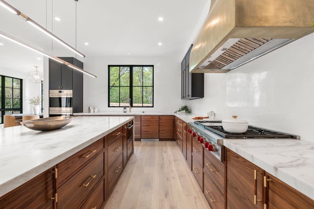 279 Fuller Street Newton, MA 02465 - Photo 15 of 42 a kitchen with stainless steel appliances granite countertop a sink a stove and a wooden floors
