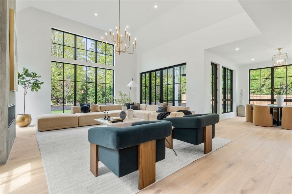 279 Fuller Street Newton, MA 02465 - Photo 24 of 42 a living room with furniture a chandelier and a large window