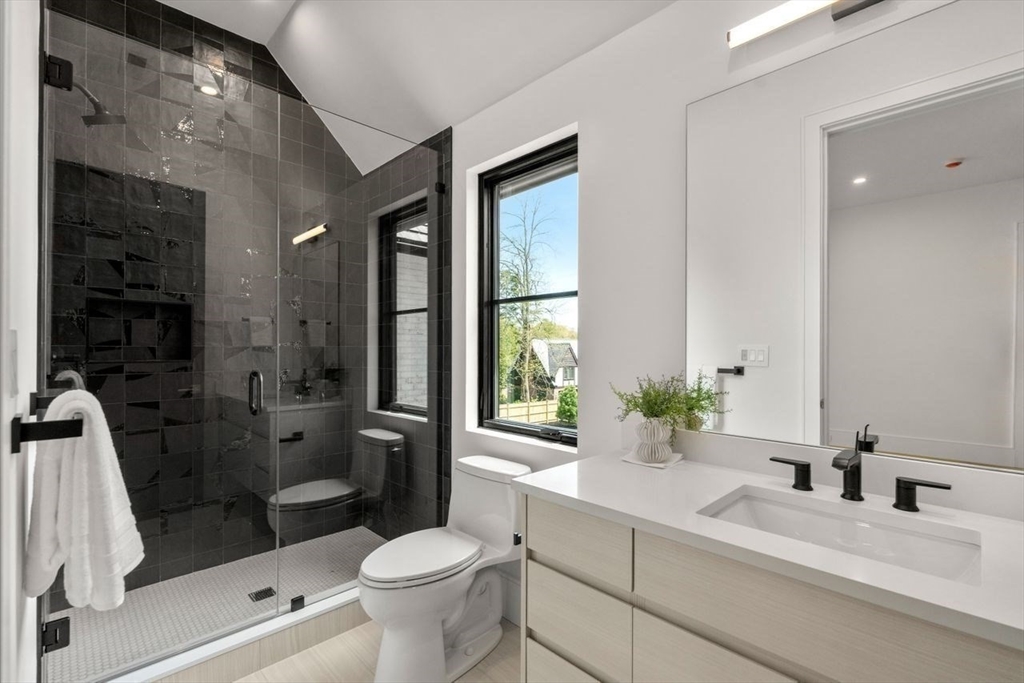 279 Fuller Street Newton, MA 02465 - Photo 37 of 42 a bathroom with a sink a toilet a glass door shower and a mirror