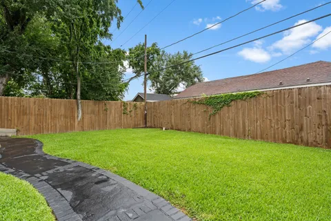 a view of a backyard with wooden fence