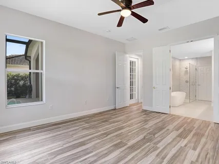 a view of a livingroom with a window and wooden floor