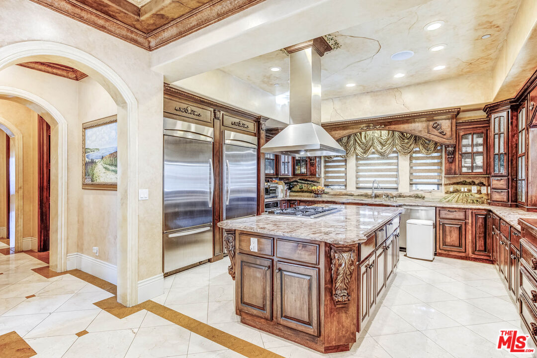 8336 Lexington Road Downey, CA 90241 - Photo 12 of 49 a kitchen with stainless steel appliances granite countertop a stove and a refrigerator