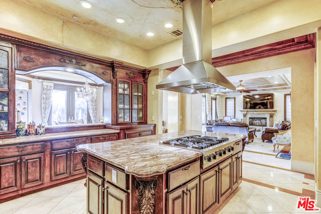 8336 Lexington Road Downey, CA 90241 - Photo 14 of 49 a kitchen with a stove a sink dishwasher and a dining table with wooden floor