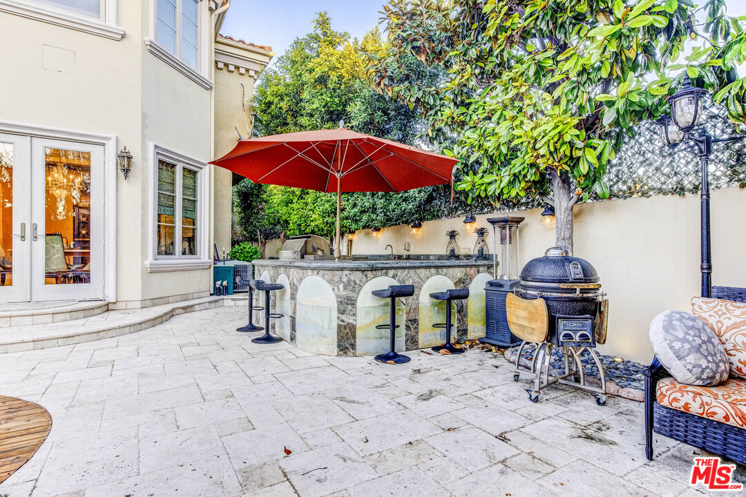 8336 Lexington Road Downey, CA 90241 - Photo 41 of 49 a view of a patio with a table and chairs under an umbrella