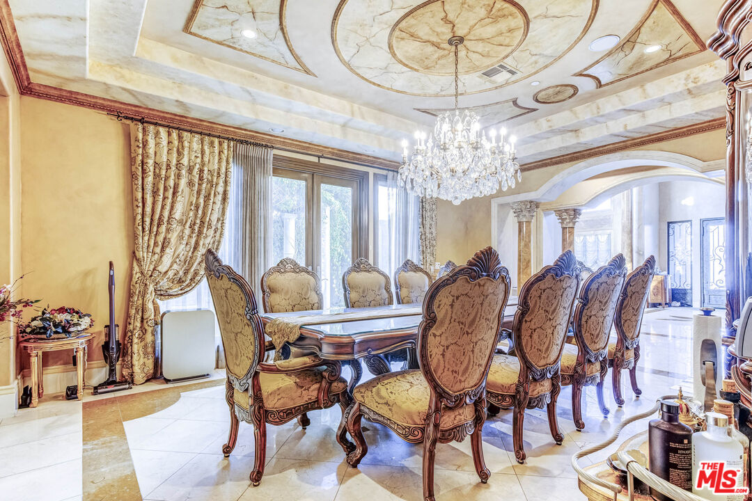 8336 Lexington Road Downey, CA 90241 - Photo 10 of 49 a view of a dining room with furniture a chandelier and large windows