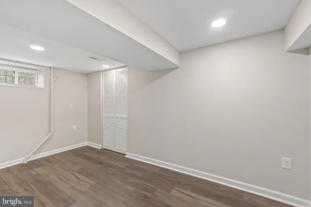 a view of room with wooden floor