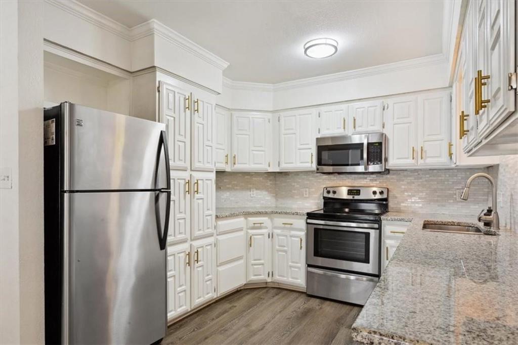 2306 Melissa Drive Waco, TX 76708 - Photo 11 of 22 a kitchen with stainless steel appliances a refrigerator stove and microwave