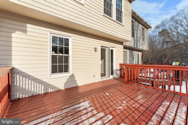 a view of a house with wooden deck
