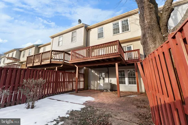 a view of a house with wooden fence