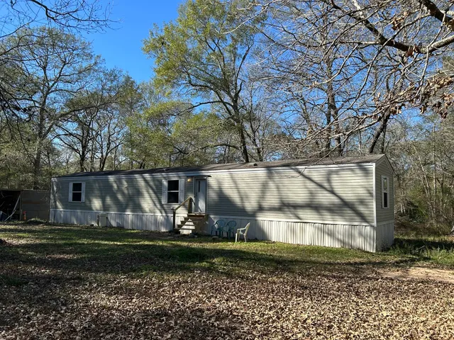 a view of backyard with wooden fence
