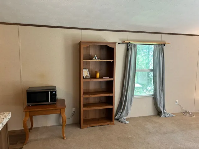 a view of room with walk in closet and window
