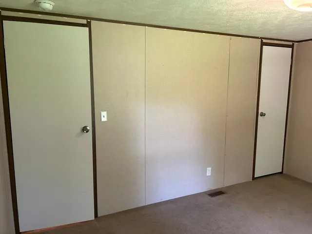 a bathroom with a granite countertop bathtub sink vanity mirror and toilet