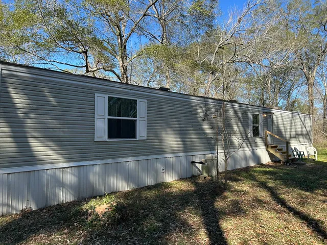 a house that has a tree in front of it