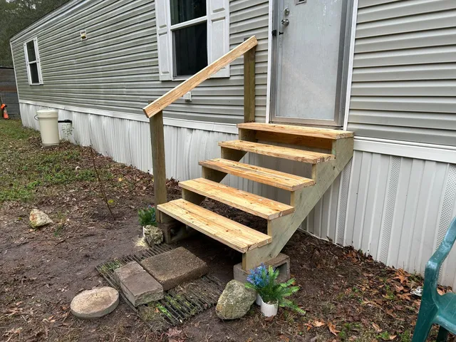 a view of a backyard with chairs and a stove