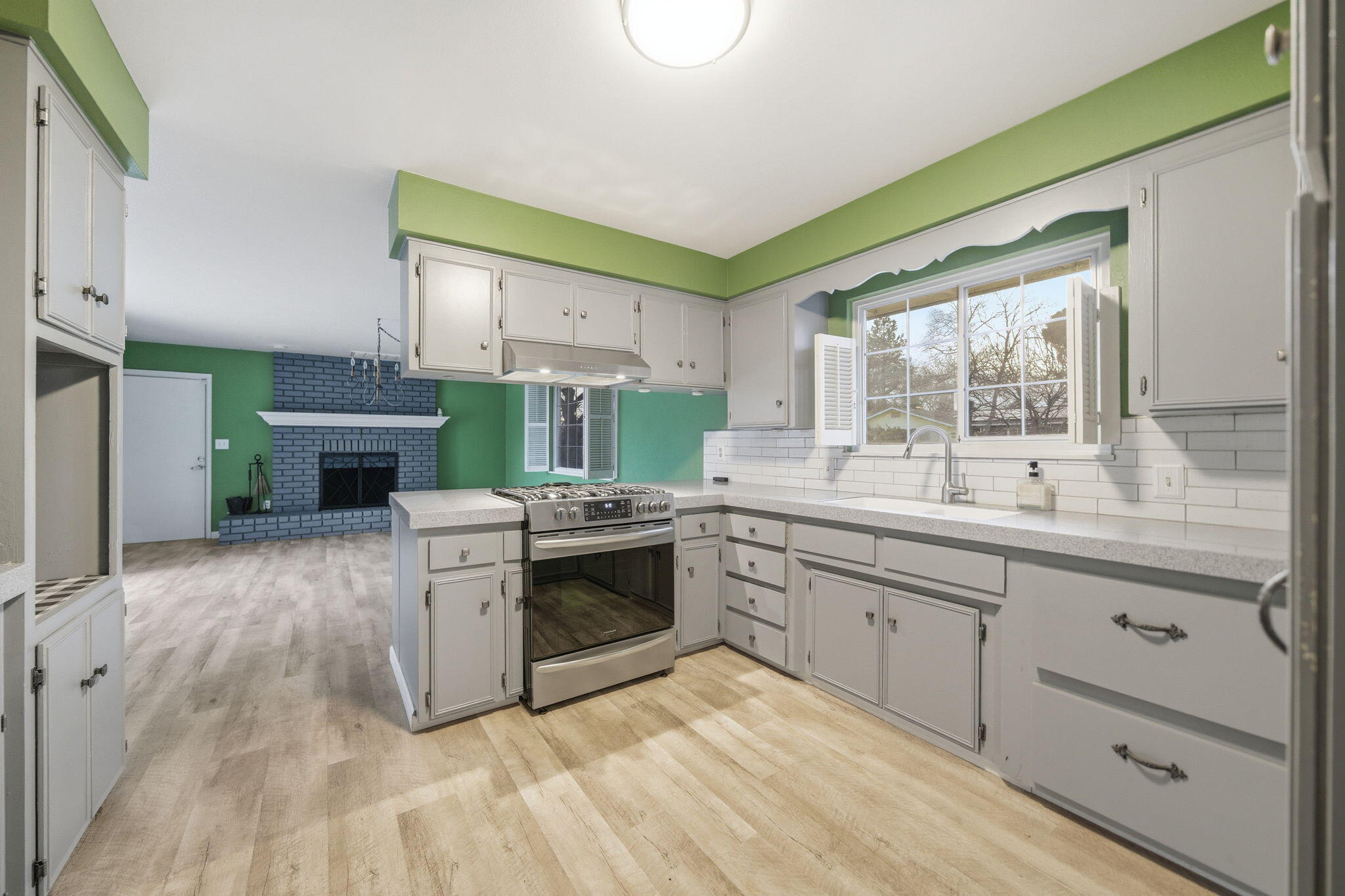 6927 Riata Drive Redding, CA 96002 - Photo 12 of 39 a kitchen with stainless steel appliances granite countertop a stove a sink and a refrigerator