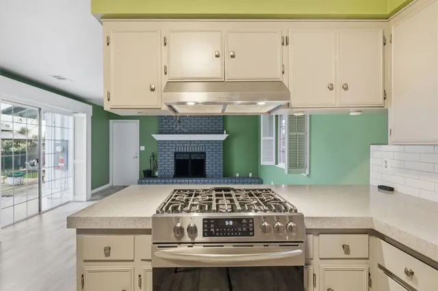 a kitchen with cabinets and a refrigerator