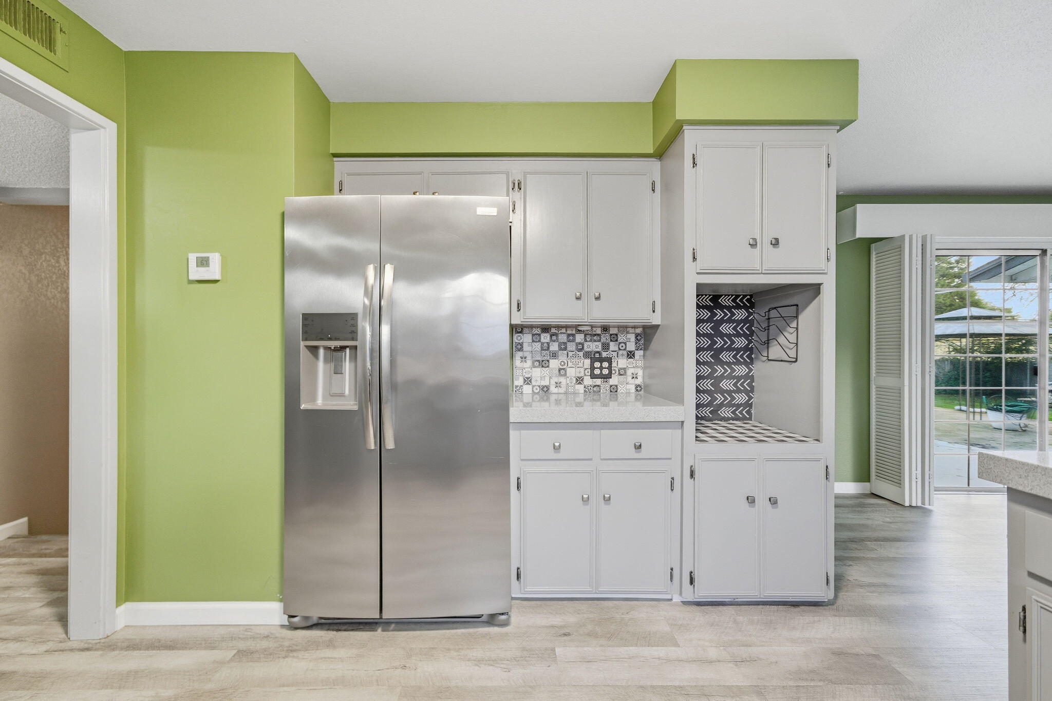 6927 Riata Drive Redding, CA 96002 - Photo 15 of 39 a kitchen with cabinets and a refrigerator