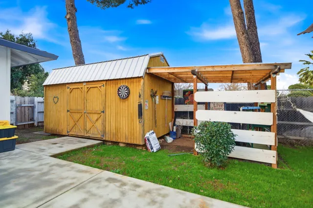 a view of a swimming pool with a yard and plants