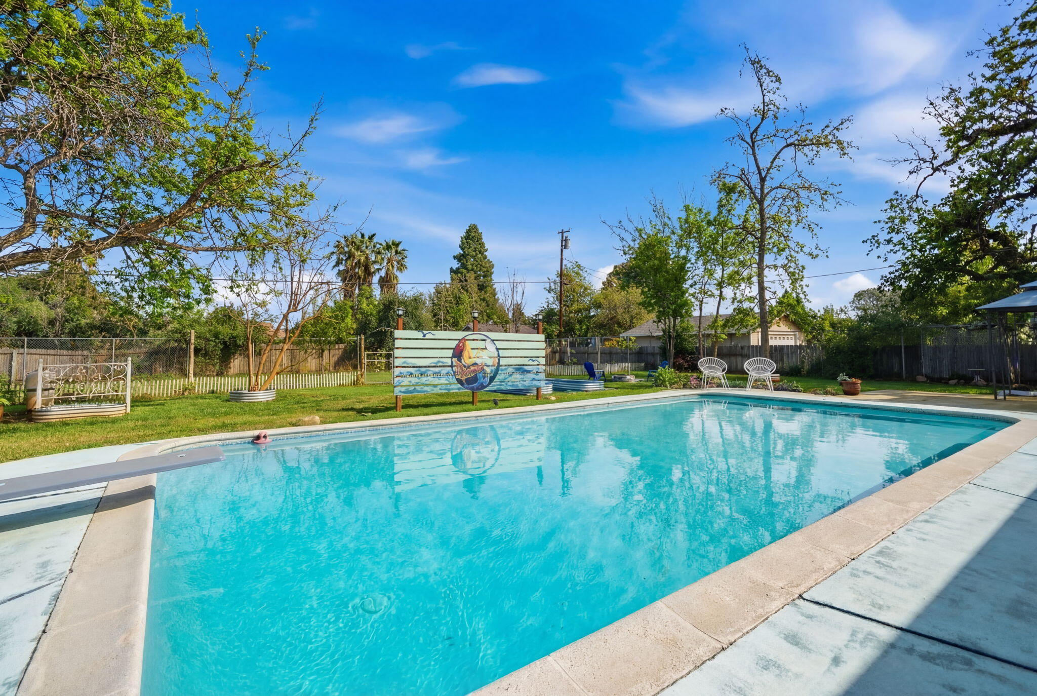 6927 Riata Drive Redding, CA 96002 - Photo 37 of 39 a view of a swimming pool with a yard and plants
