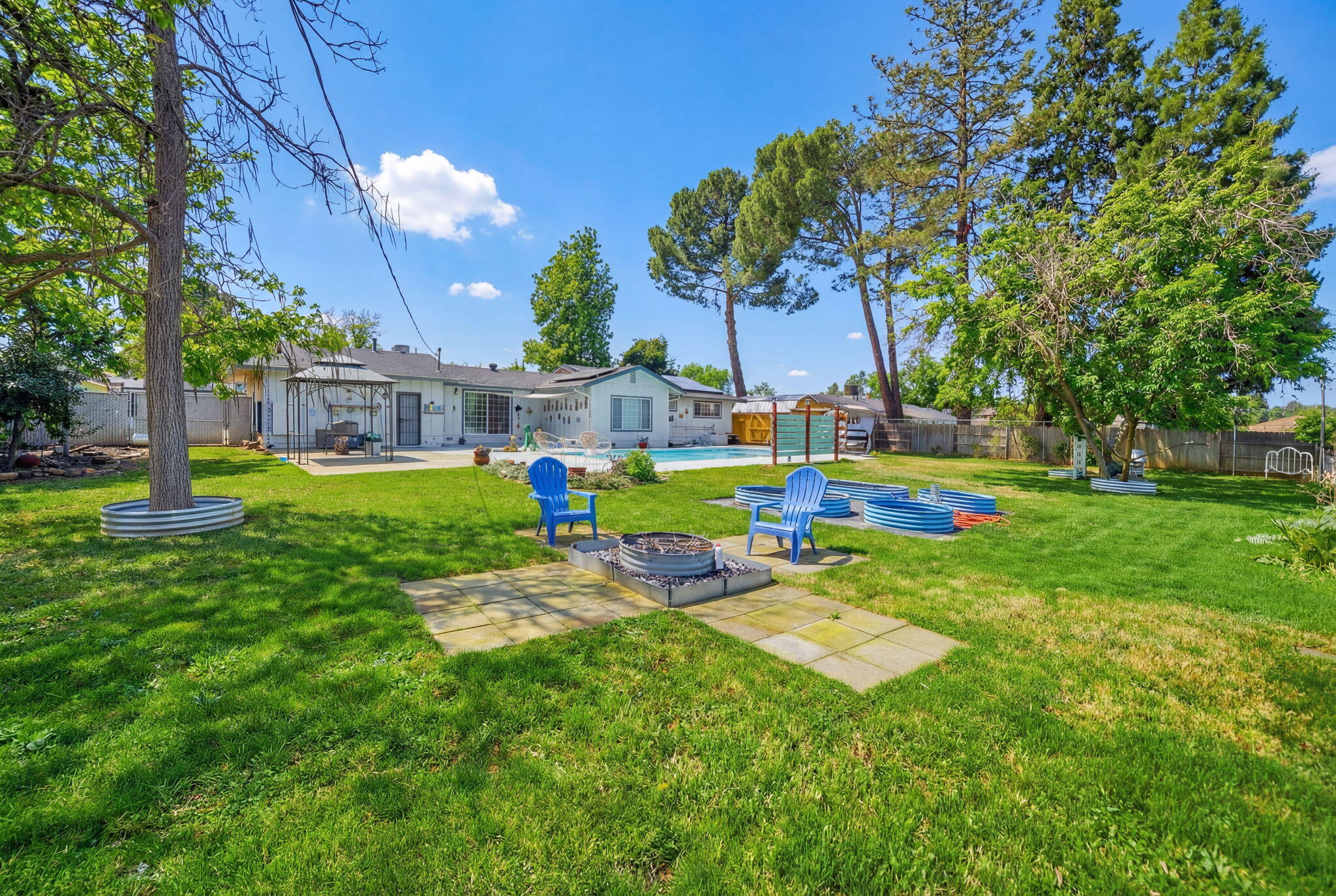 6927 Riata Drive Redding, CA 96002 - Photo 38 of 39 a view of a house with a yard and sitting area