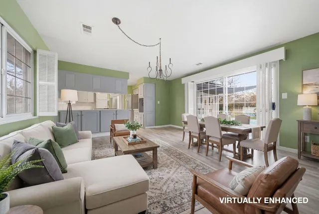 a living room with fireplace furniture and a large window