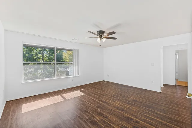 wooden floor in an empty room with a window