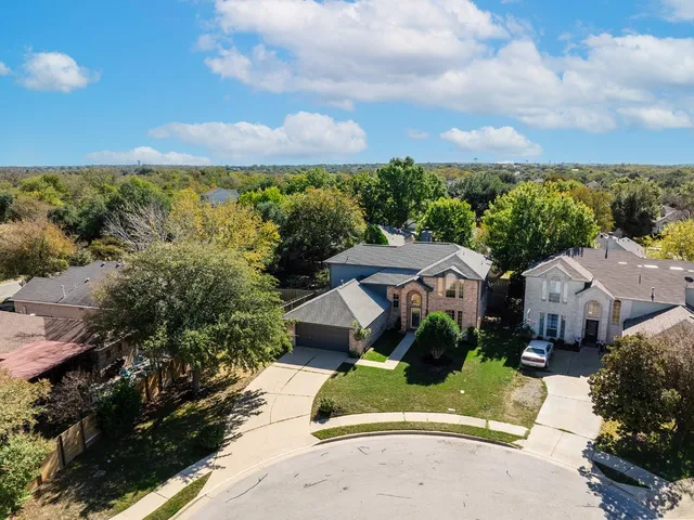 an aerial view of a houses with a garden