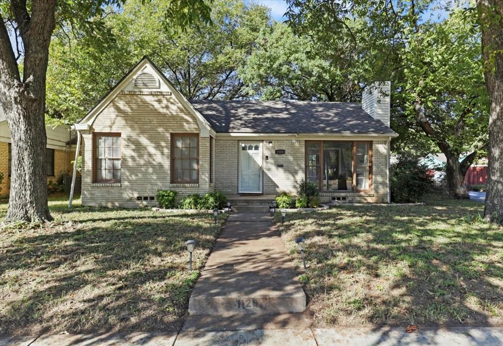 1129 North Riverside Drive Fort Worth, TX 76111 - Photo 2 of 29 a front view of a house with garden