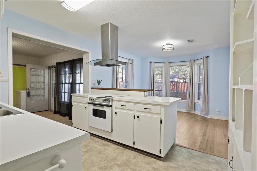 1129 North Riverside Drive Fort Worth, TX 76111 - Photo 23 of 29 a kitchen with cabinets and stainless steel appliances