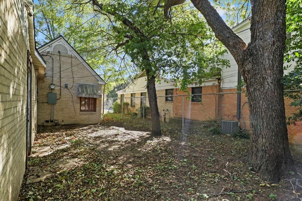 1129 North Riverside Drive Fort Worth, TX 76111 - Photo 26 of 29 a view of a house with a tree in the yard