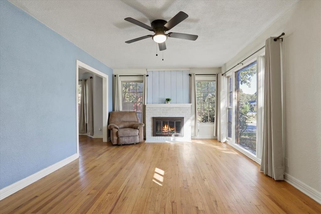 1129 North Riverside Drive Fort Worth, TX 76111 - Photo 7 of 29 a living room with furniture and a fireplace