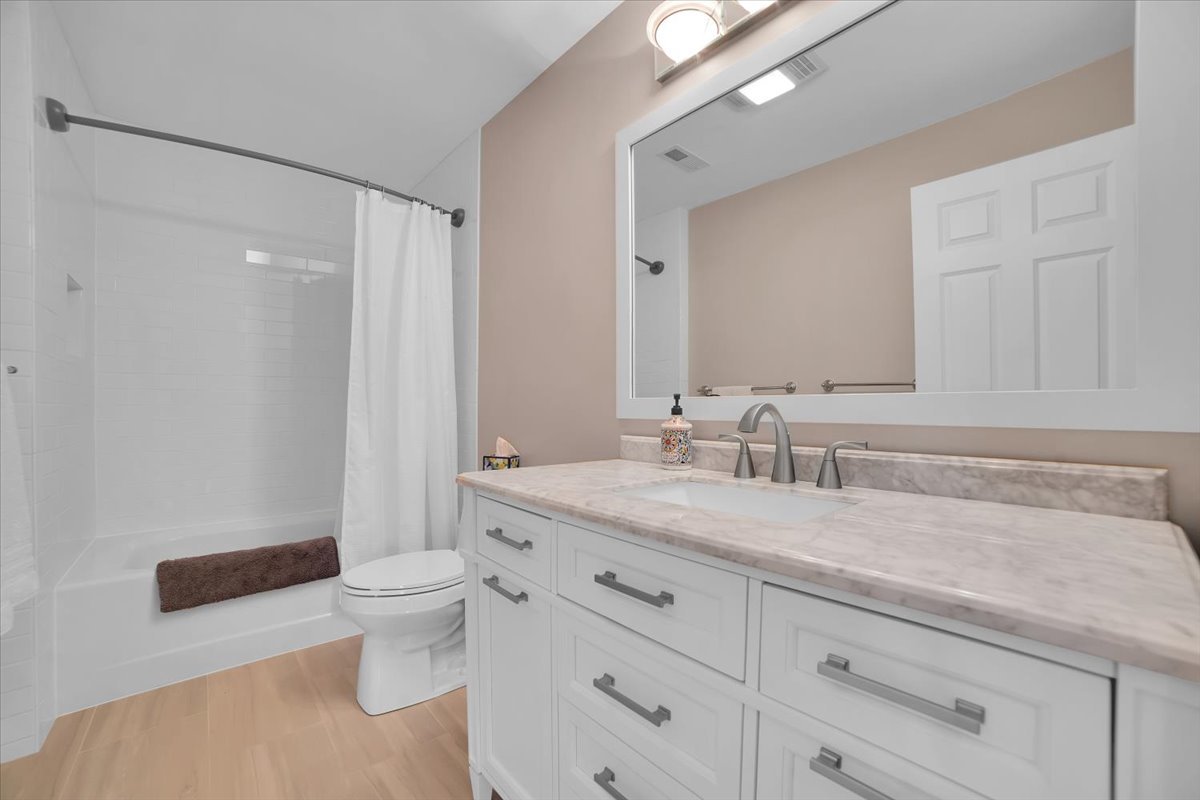 7N395 Ridge Line Road St. Charles, IL 60175 - Photo 30 of 40 a bathroom with a granite countertop sink a toilet and a mirror