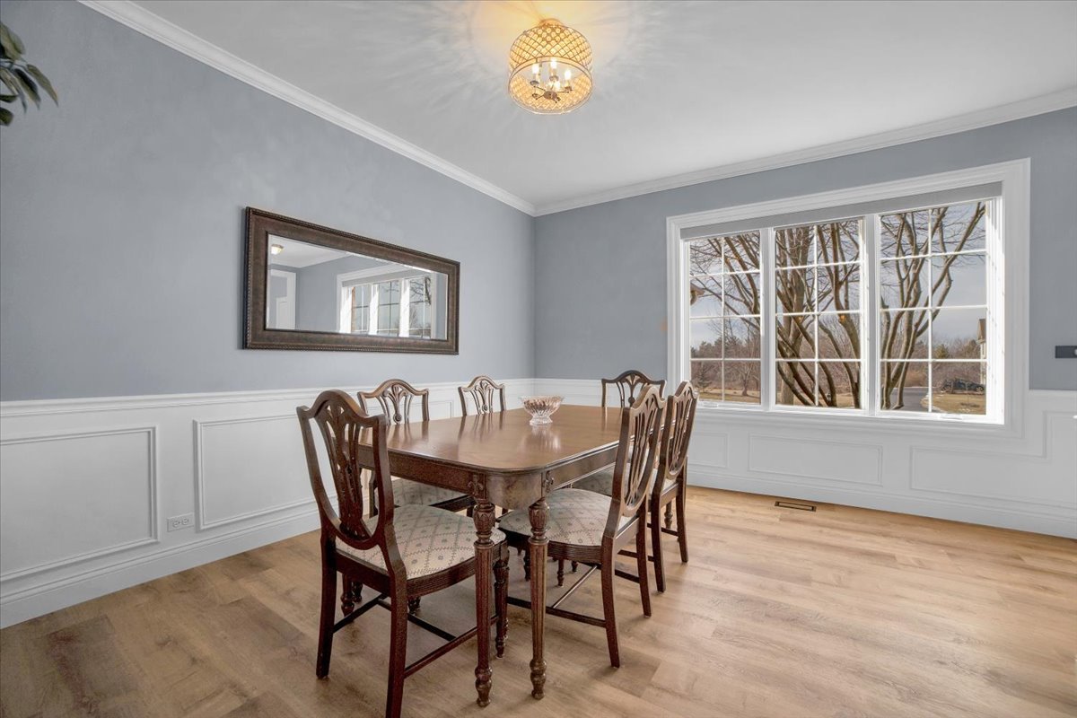 7N395 Ridge Line Road St. Charles, IL 60175 - Photo 9 of 40 a view of a dining room with furniture a chandelier and wooden floor