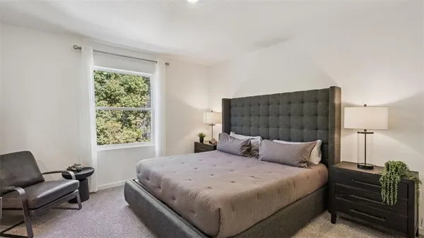 a bedroom with a bed and a couch