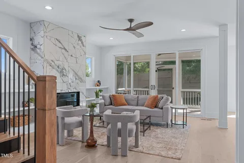 a kitchen with a sink a stove and chairs